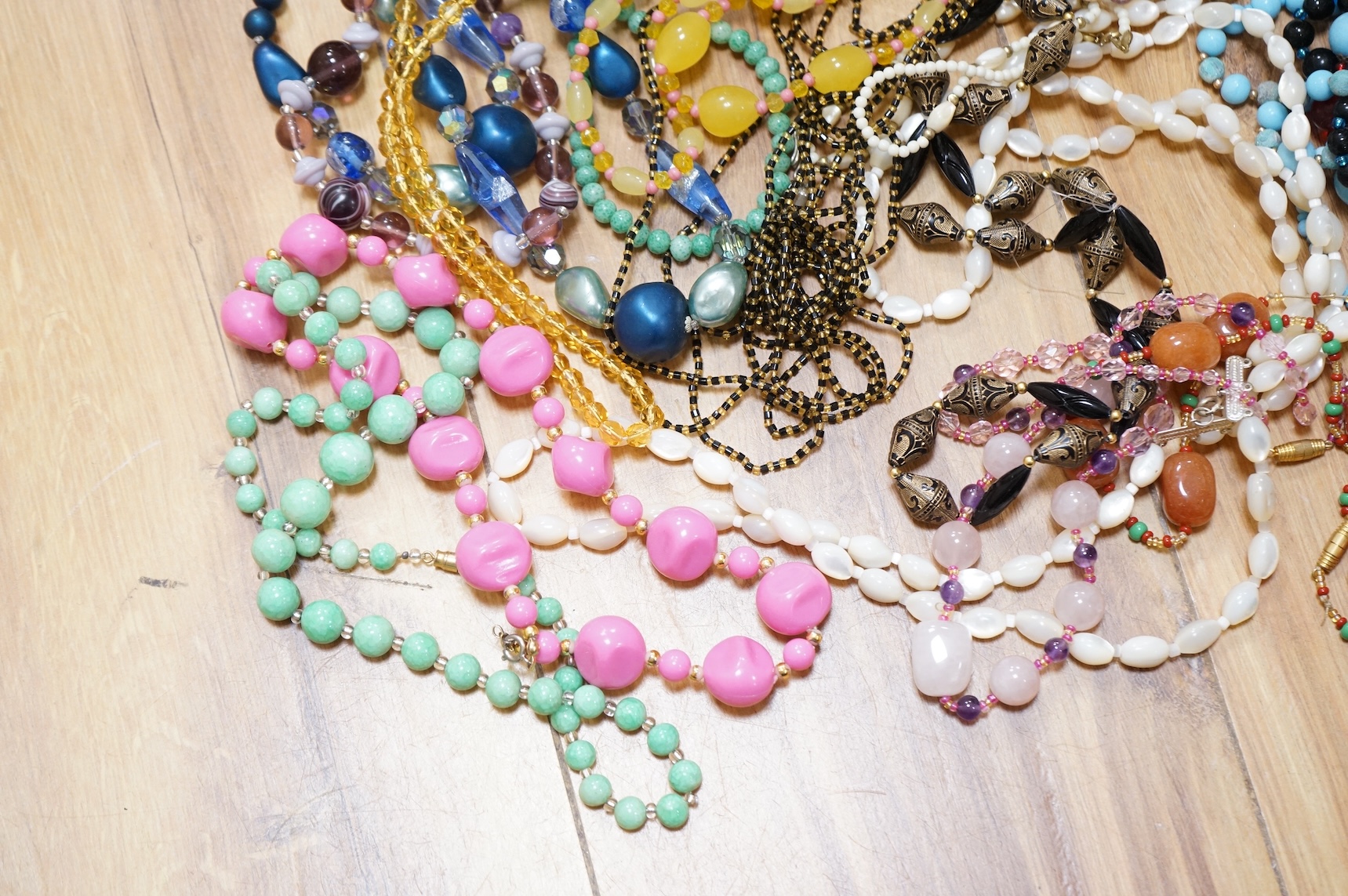 A large collection of glass bead necklaces